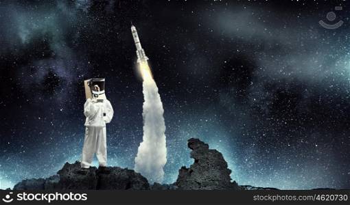 Dreaming to explore space. Young woman with carton box on head imagine she is astronaut