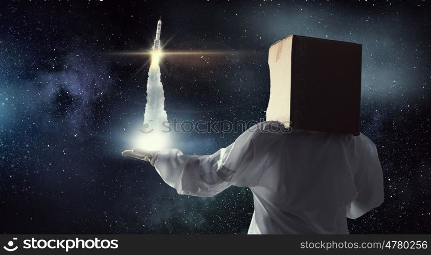 Dreaming to explore space. Young woman with carton box on head imagine she is astronaut