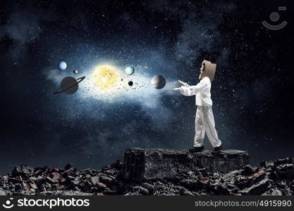 Dreaming to explore space. Young woman with carton box on head imagine she is astronaut