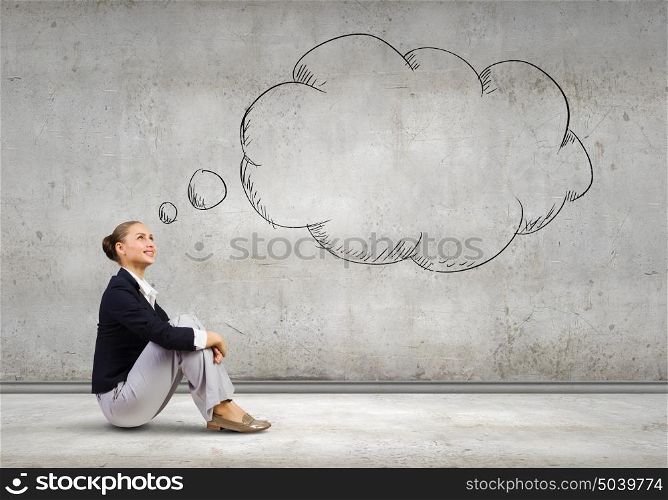 Dreaming woman. Young pretty lady sitting on floor and dreaming