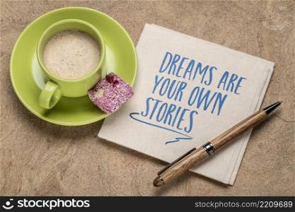 dreams are your own stories inspirational handwriting on a napkin with a cup of coffee