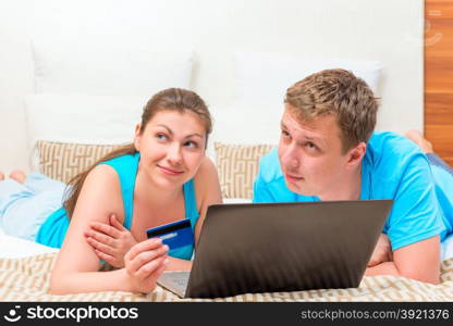 dreamy happy couple with a credit card to shop online