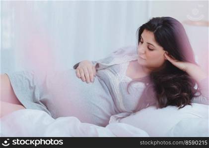 Dreamy Peaceful Pregnant Woman Relaxing at Home. Enjoying Calm Pregnancy Period. Happy Motherhood. Love Concept.. Happy Female Enjoying Pregnancy
