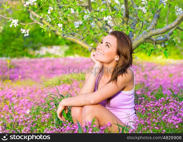 Dreamy woman spending time in blooming park, enjoying first blossom of nature, happy weekend in countryside, relaxation outdoors&#xA;