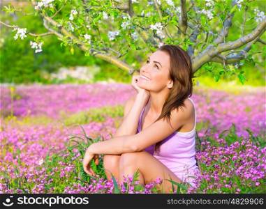 Dreamy woman spending time in blooming park, enjoying first blossom of nature, happy weekend in countryside, relaxation outdoors&#xA;