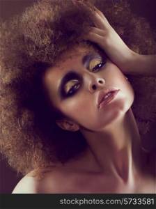 Dreamy Woman with Frizzy Hairstyle and Golden Eyeshadow