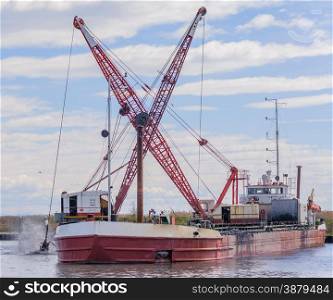Dredger ship navy working to clean a navigation channel
