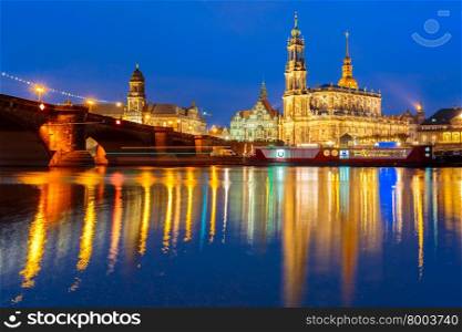 Dresden Cathedral of the Holy Trinity aka Hofkirche Kathedrale Sanctissima Trinitatis and Augustus Bridge with reflections in the river Elbe at night in Dresden, Saxony, Germany