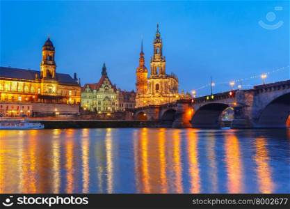 Dresden Cathedral of the Holy Trinity or Hofkirche, Bruehl&amp;#39;s Terrace or The Balcony of Europe and Augustus Bridge with reflections in the river Elbe at night in Dresden, Saxony, Germany