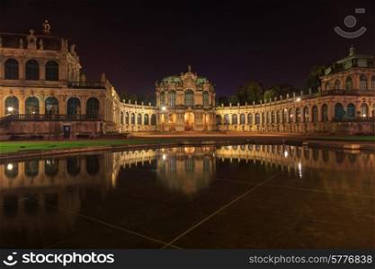 Dresden Zwinger palace panorama with illumination at night and water reflection, Germany&#xA;