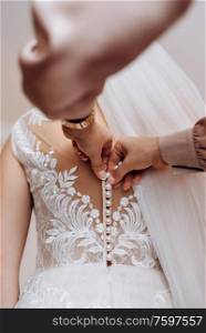 dress up the bride in a wedding dress with corset and lacing