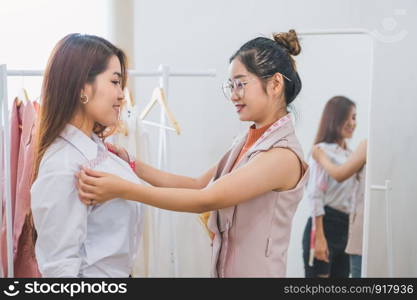 Dressmaker measuring female customer shoulder and chest in sewing atelier workshop office. Tailor and fashion designer concept. Job and freelance occupation. Business people in clothing shop