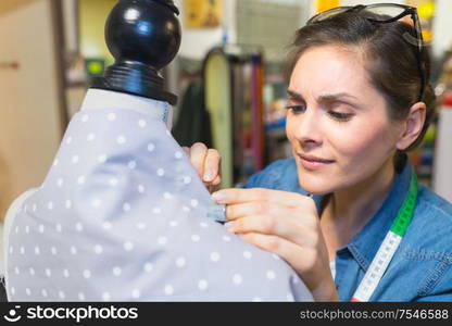 dressmaker working with a cloth dummy