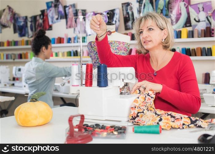 dressmaker working with an assistant in the background