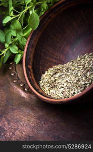 dried and fresh oregano herb on retro background. spice oregano herb