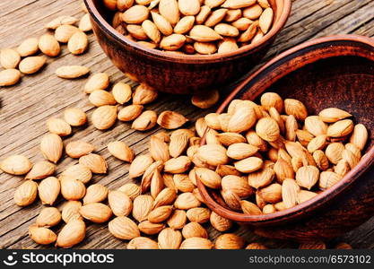 Dried apricot kernel on a wooden table. Cleaned kernels apricots