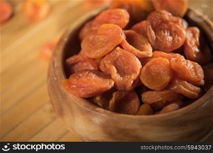 Dried apricots in a bowl. Dried apricots in a wooden bowl