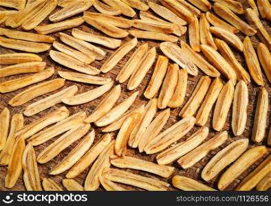 Dried banana background / Organic banana long slice dry on bamboo threshing basket for sun drying