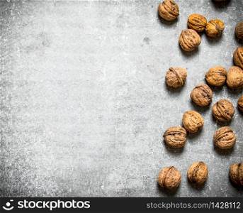 Dried big walnuts . On the stone table .. Walnuts on table .
