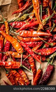 Dried chili peppers on paper. Macro background. High quality photo. Dried chili peppers on paper.