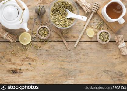 dried chinese chrysanthemum flowers teapot tea strainer honey dipper container fresh lemon tea wooden table