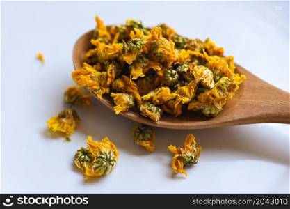 Dried chrysanthemum buds for herbal tea on white background, dry chrysanthemum flower yellow