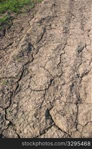 dried climate, fissured cracked earth and sand
