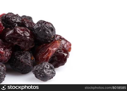 Dried cranberries, cherries and blueberries on white background