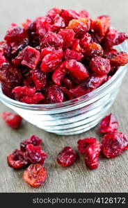 Dried cranberries spilling out of glass bowl