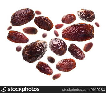 Dried dates in the shape of a heart on a white background.. Dried dates in the shape of a heart on a white background