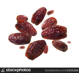 Dried dates levitate on a white background.. Dried dates levitate on a white background