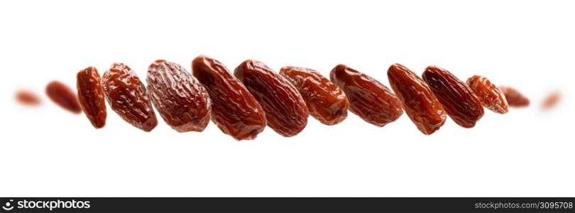 Dried dates levitate on a white background.. Dried dates levitate on a white background