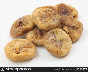 Dried figs in a pile on a white background.