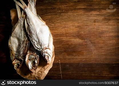 Dried fish for beer. On wooden board.. Dried fish for beer.