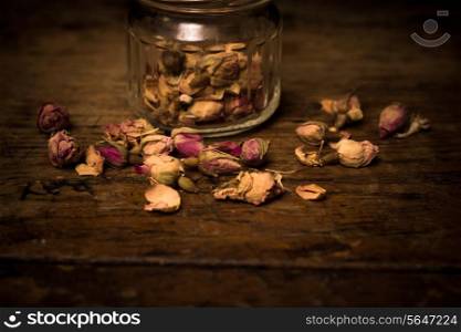 Dried flowers on wooden surface and black background