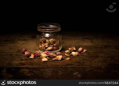 Dried flowers on wooden surface and black background