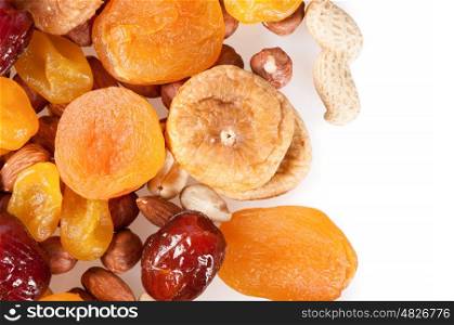 Dried fruits, dates, lemon, apricots, figs and nuts on a white background.