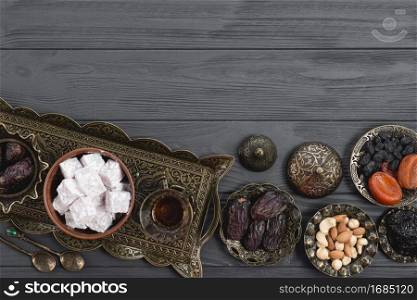 dried fruits nuts dates lukum tea ramadan wooden desk