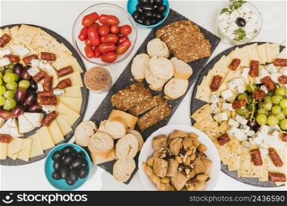 dried fruits olives tomatoes cheese platter with grapes smoked sausages