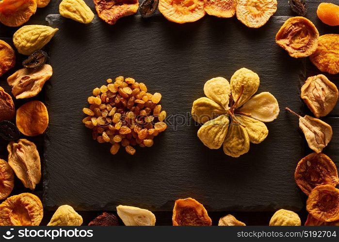 Dried fruits on slate plate background
