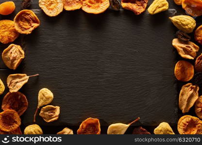 Dried fruits on slate plate background