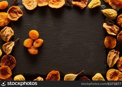 Dried fruits on slate plate background