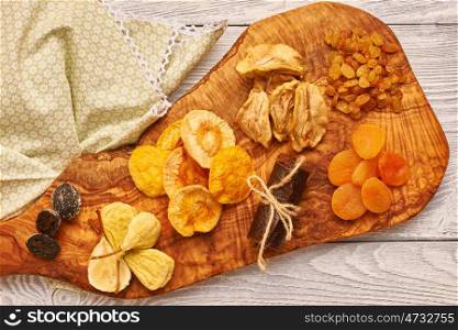 Dried fruits on vintage rustic wooden background