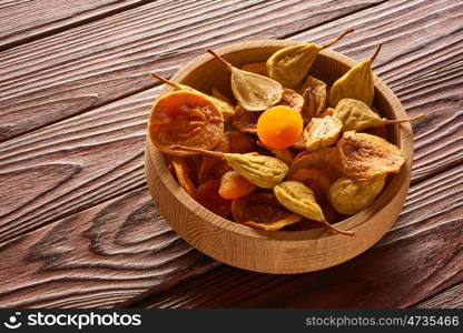 Dried fruits on vintage rustic wooden background