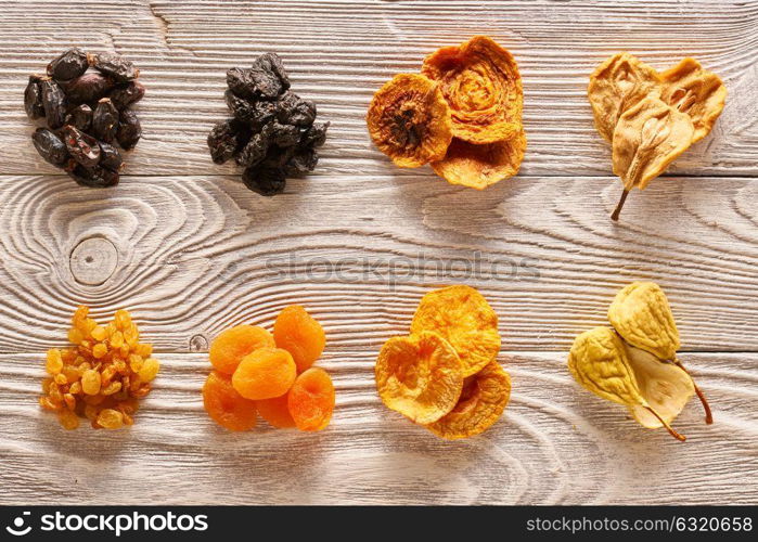 Dried fruits on vintage rustic wooden background