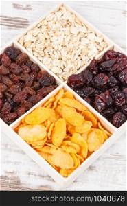 Dried fruits with various flakes as source carbohydrates, dietary fiber, vitamins and minerals, concept of healthy and nutritious eating. Dried fruits with various flakes as source carbohydrates, vitamins and fiber, nutritious eating