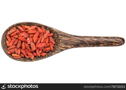 dried goji berries on a wooden spoon isolated on white - superfood concept
