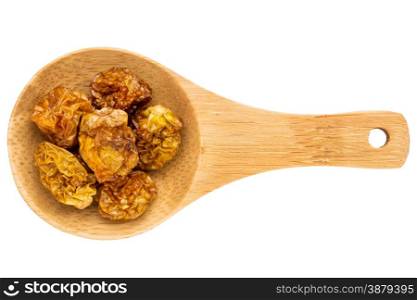 dried goldenberries on a small wooden spoon isolated on white with a clipping path