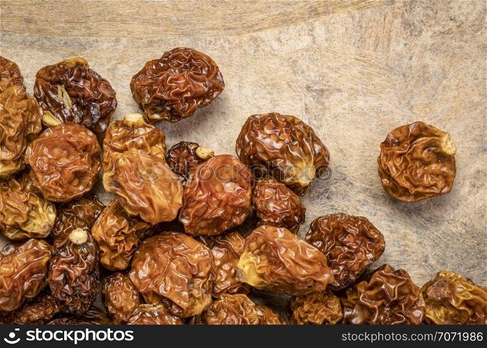 dried goldenberries on a textured bark paper background
