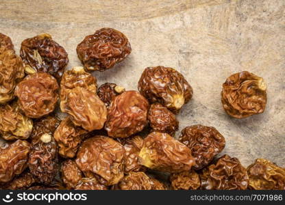 dried goldenberries on a textured bark paper background